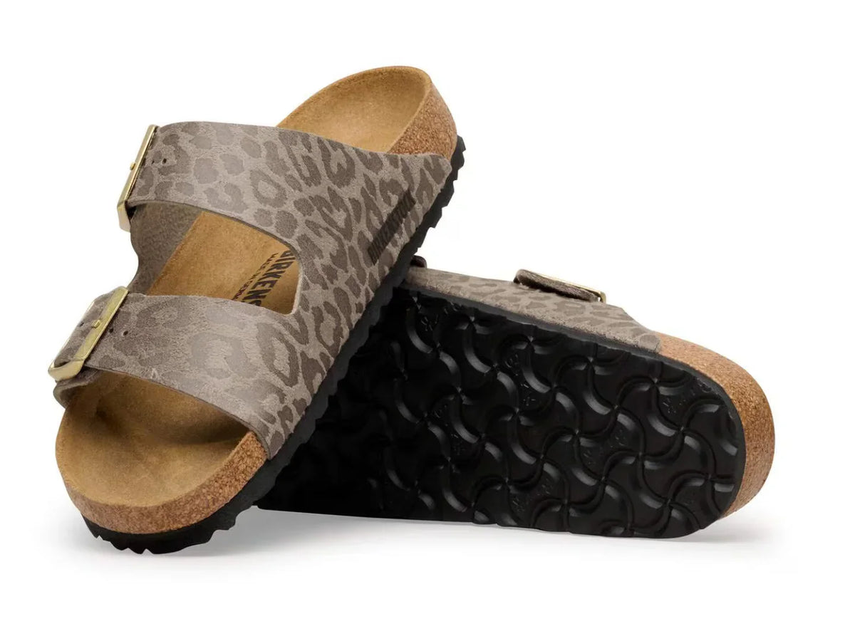 Pair of brown leopard print two-strap sandals with cork footbeds and black rubber soles