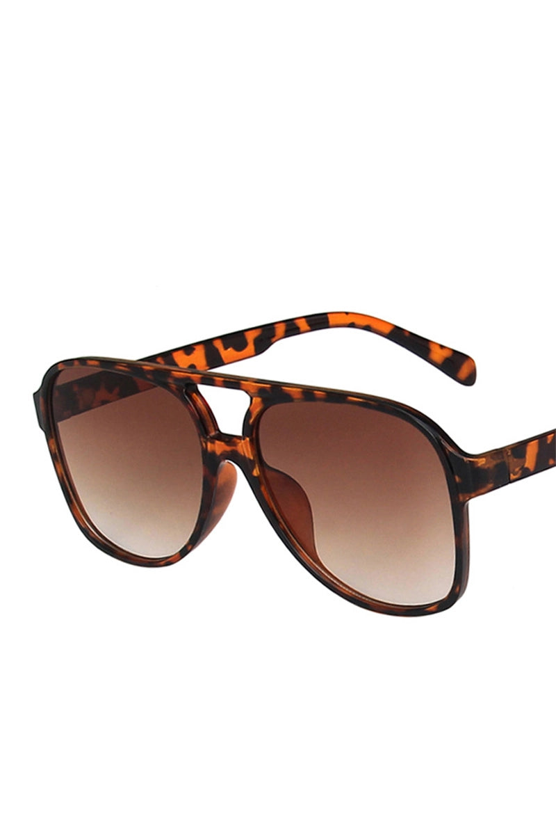 Sunglasses with tortoiseshell frame and brown gradient lenses on a white background