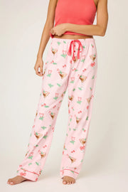 Person wearing pink pajama pants with a pattern on a white background