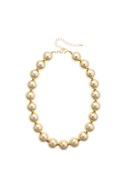 A gold-plated beaded necklace with large, polished spherical beads and a delicate gold chain extender clasp, shown on a plain white background.