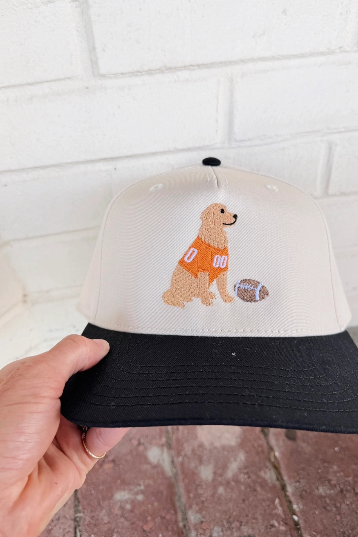 black and white baseball cap with golden retriever at jcole shoes tulsa