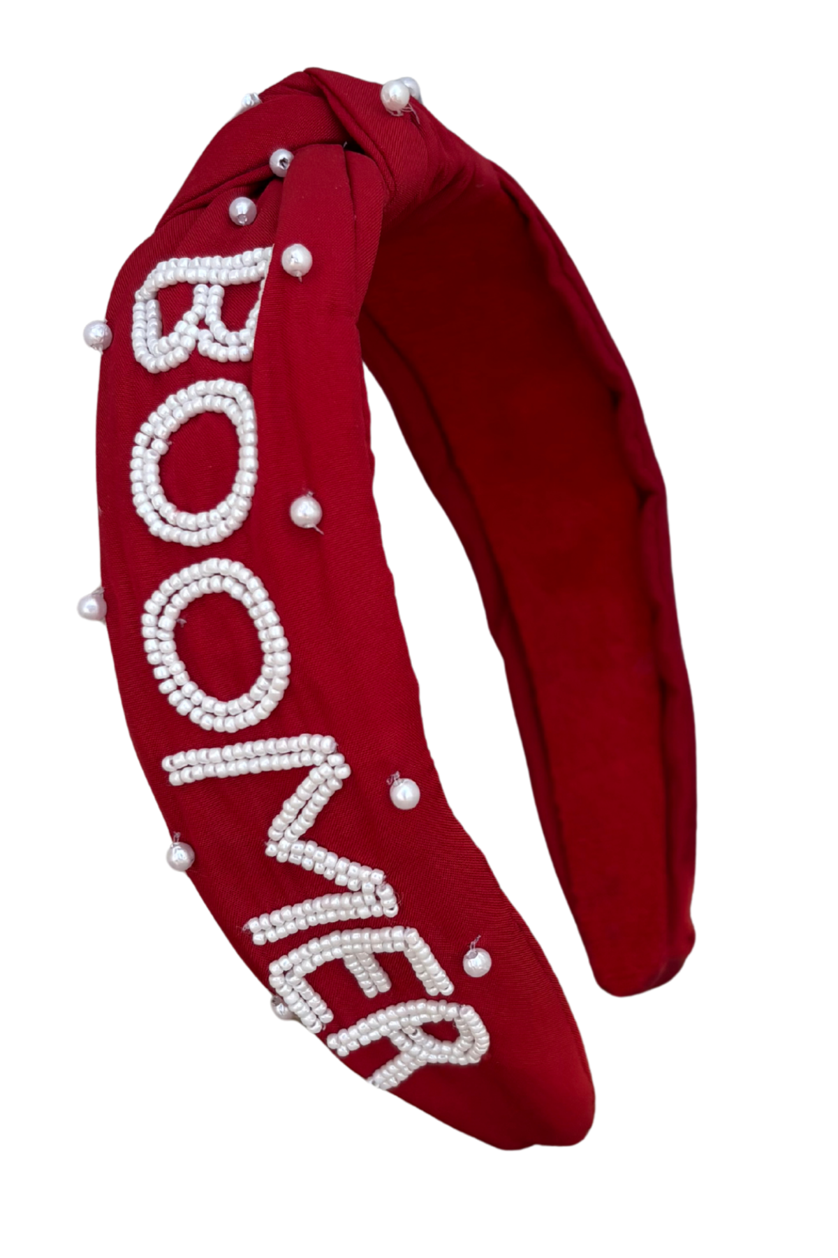 A wide red fabric headband featuring the word 'BOOMER' in raised white lettering embellished with small pearls, accented with scattered pearl beads on the front, shown against a plain white background.