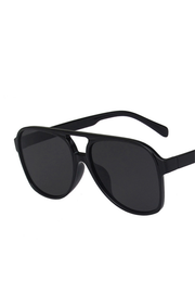 Black aviator-style sunglasses with a thick double bridge and dark lenses, shown at an angle on a plain white background.