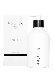 A white bottle of bou'ee scented body oil with a black pump next to its white packaging box, both featuring the brand name 'bou'ee' and the variant 'original' on a clean white background.
