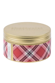 A round metal tin with a gold lid and a red, pink, and white plaid pattern band around the body, photographed on a plain white background.