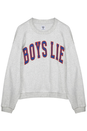 A light heather gray crewneck sweatshirt featuring the phrase 'BOYS LIE' printed across the chest in arched varsity-style block letters with a red outline and blue fill.
