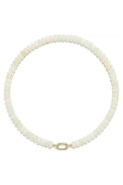 A beaded necklace made of small, round, off-white beads with a polished gold oval link clasp, displayed on a clean white background.