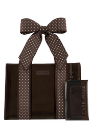 A brown tote bag with white polka-dot handles, shown with a matching clear phone pouch branded CASE-MATE on a white background.