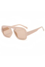 A pair of oversized square sunglasses with a thick matte beige frame and matching beige lenses, shown on a clean white background.