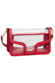 A clear plastic pouch bag with a bright red faux-leather trim and strap, featuring a gold-tone snap button closure on a white background.