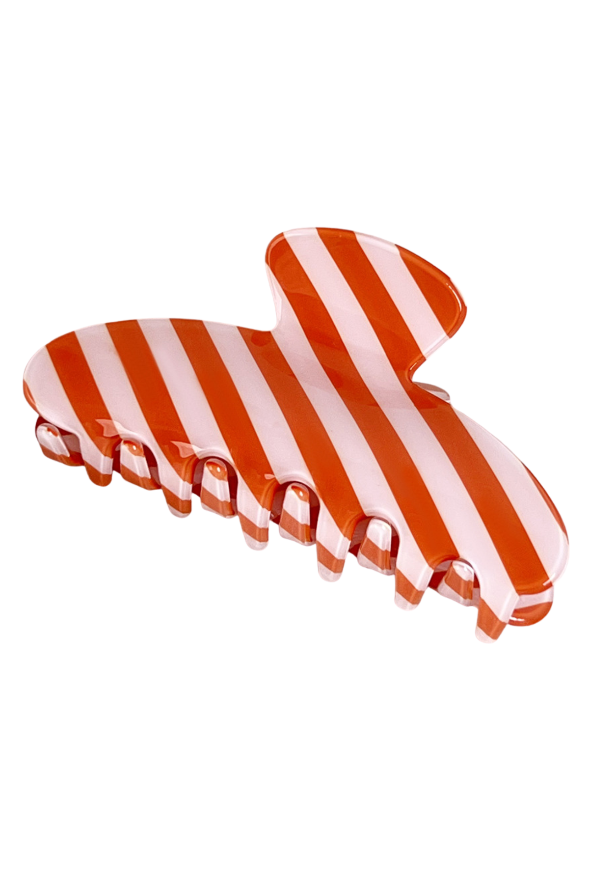 A glossy hair claw clip with alternating orange and white diagonal stripes, shown on a plain white background.