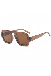 A pair of oversized square sunglasses with translucent brown frames and matching brown lenses, shown on a plain white background.