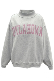 A light gray heather sweatshirt with a mock neck collar and 'OKLAHOMA' printed in pink arched block letters across the chest, displayed on a clean white background.