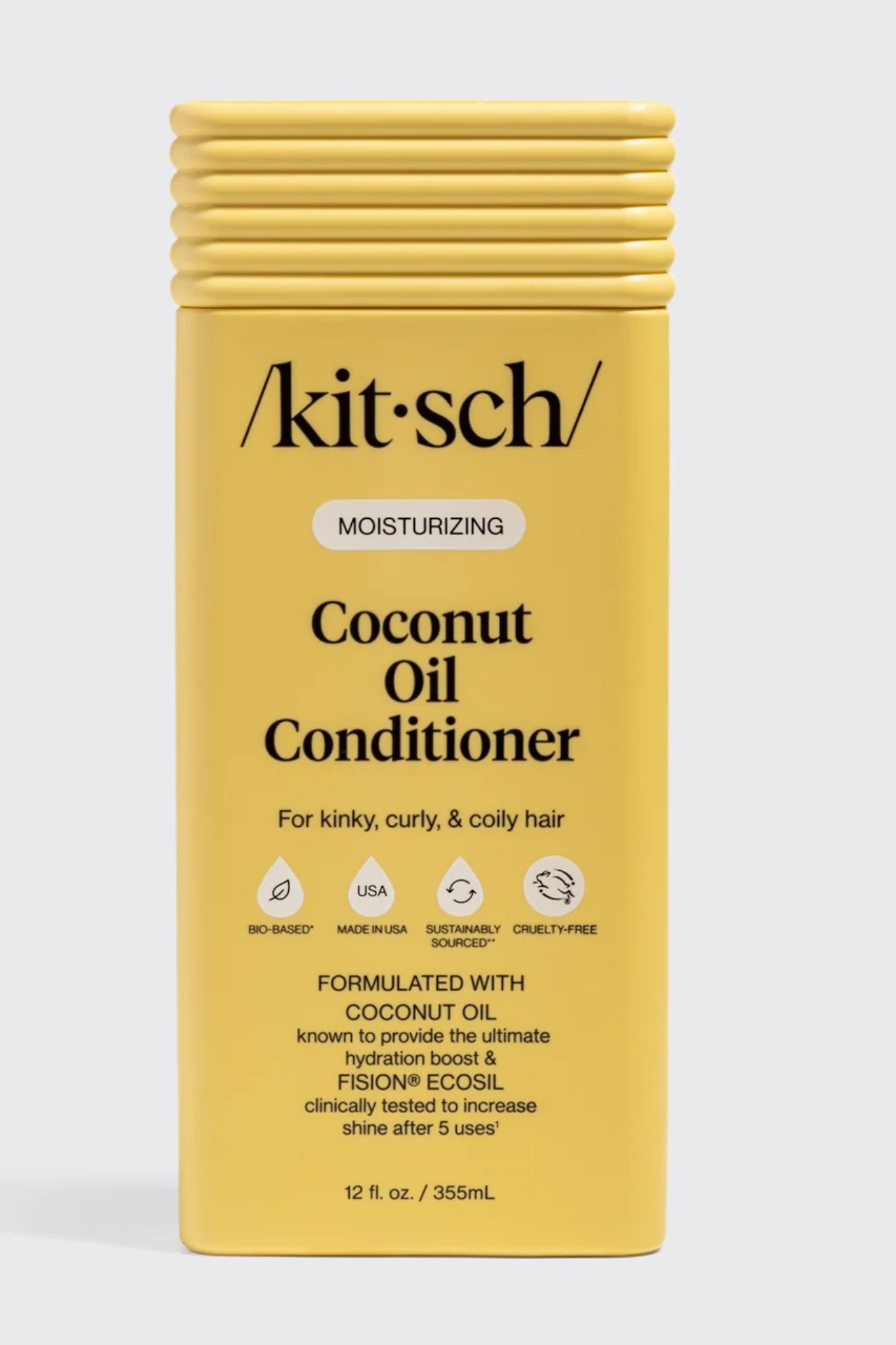 Kit-Sch Coconut Oil Conditioner in a yellow rectangular bottle with a ribbed cap, shown against a light gray background.