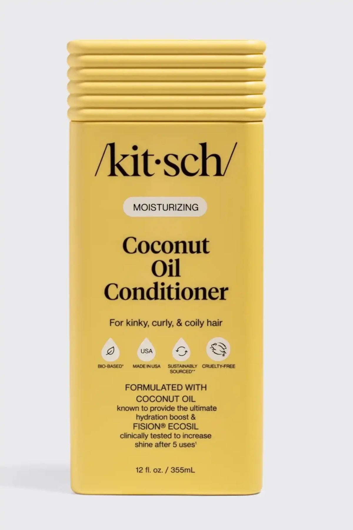 Kit-Sch Coconut Oil Conditioner in a yellow rectangular bottle with a ribbed cap, shown against a light gray background.