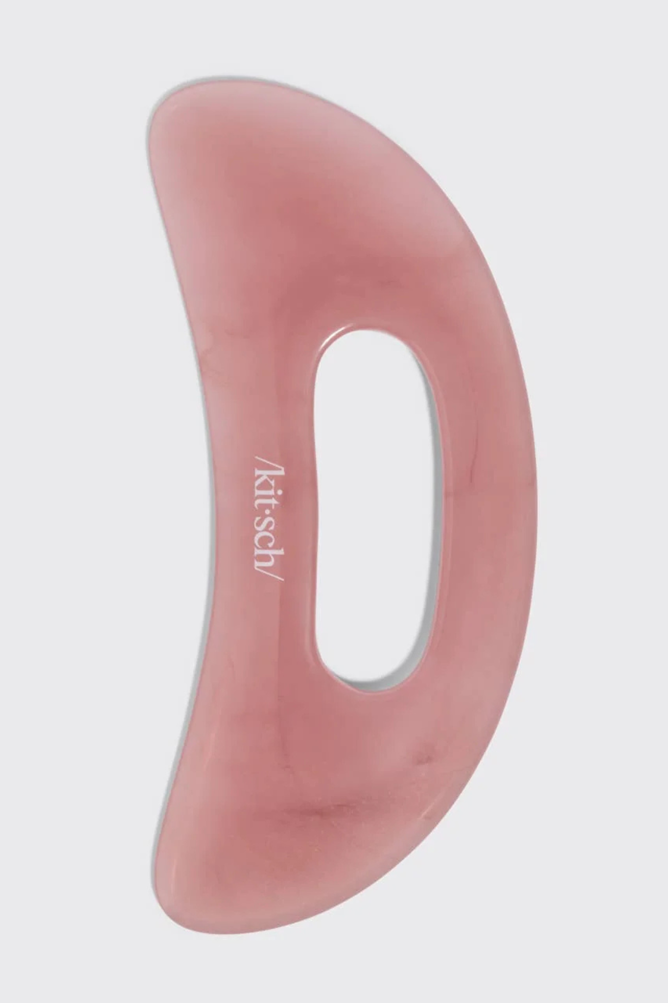 A pink jade Gua sha facial massage tool with a semi-translucent finish and the brand name 'Atitsch' printed on it, shown against a light gray background.