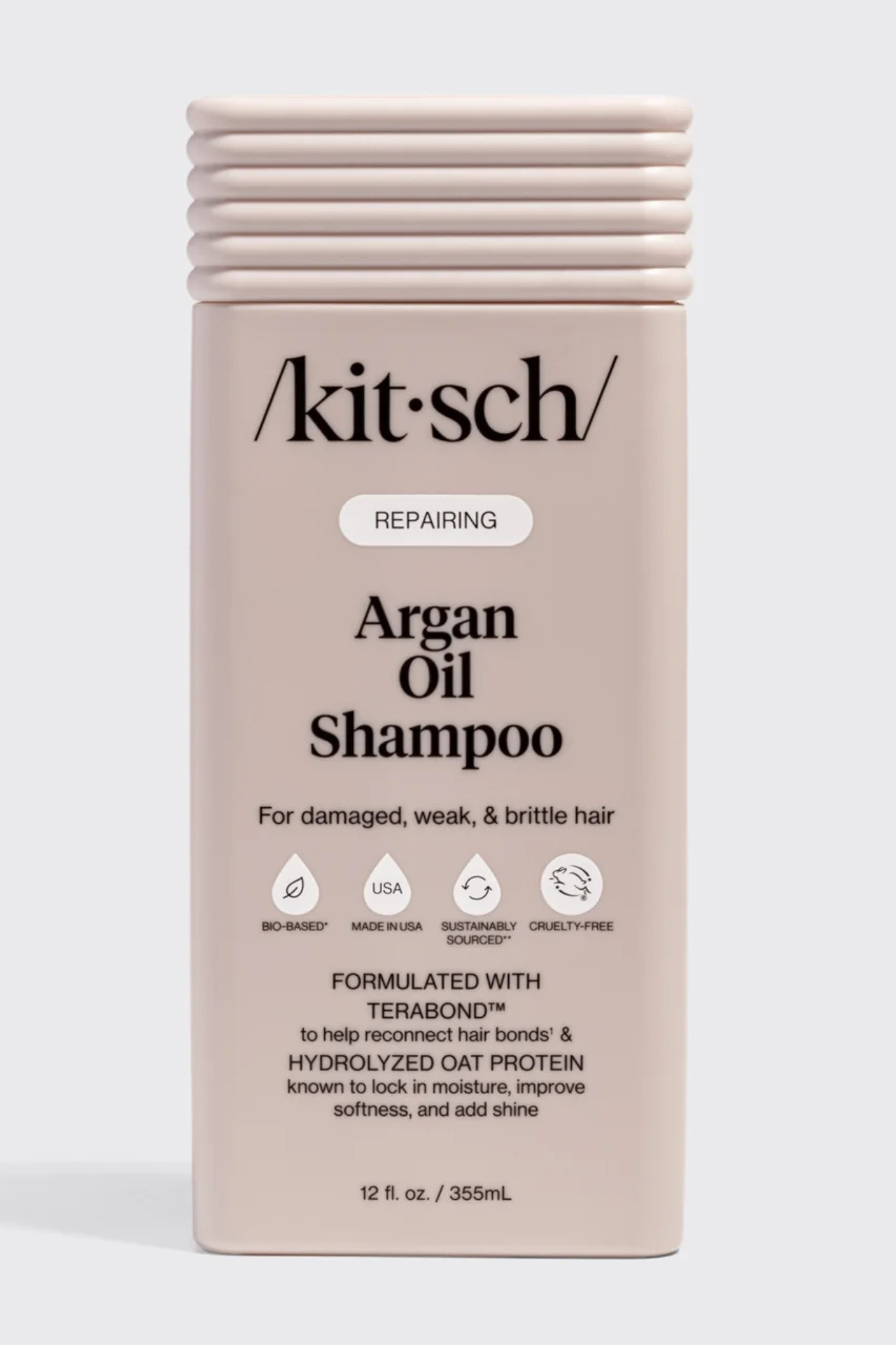Kitsch Repairing Argan Oil Shampoo in a rectangular beige bottle with a ribbed cap, shown against a light gray background.