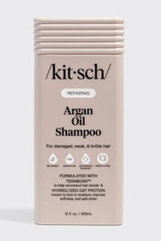 Kitsch Repairing Argan Oil Shampoo in a rectangular beige bottle with a ribbed cap, shown against a light gray background.