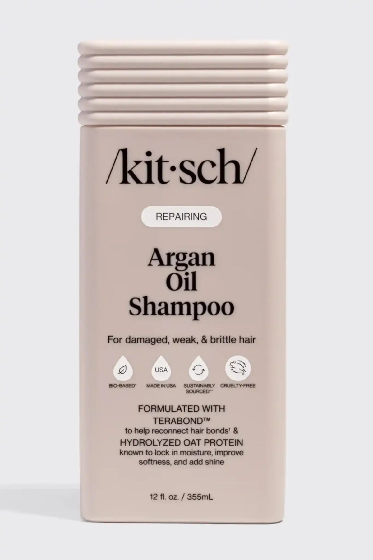 Kitsch Repairing Argan Oil Shampoo in a rectangular beige bottle with a ribbed cap, shown against a light gray background.