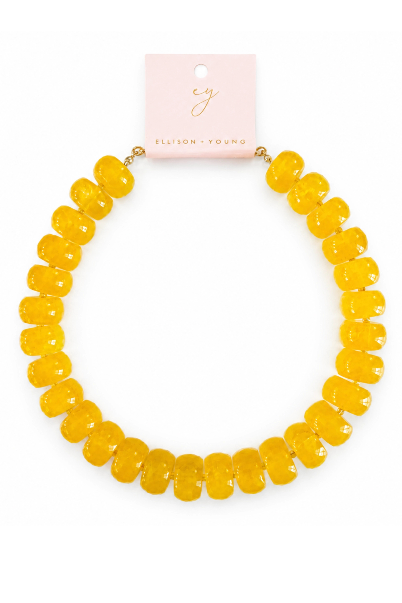 A yellow beaded necklace with chunky, rounded faceted beads, displayed on a light pink card from Ellison & Young against a white background.