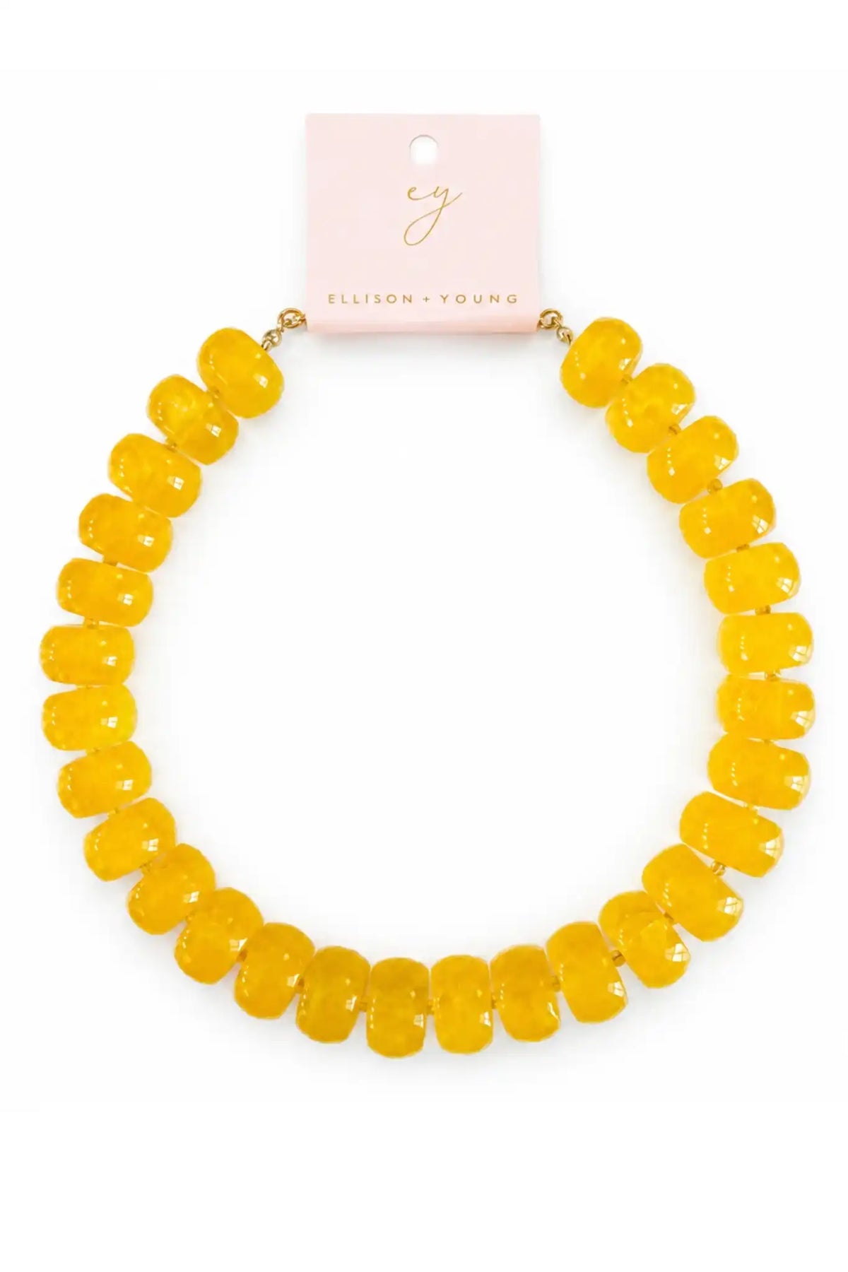 A yellow beaded necklace with chunky, rounded faceted beads, displayed on a light pink card from Ellison & Young against a white background.