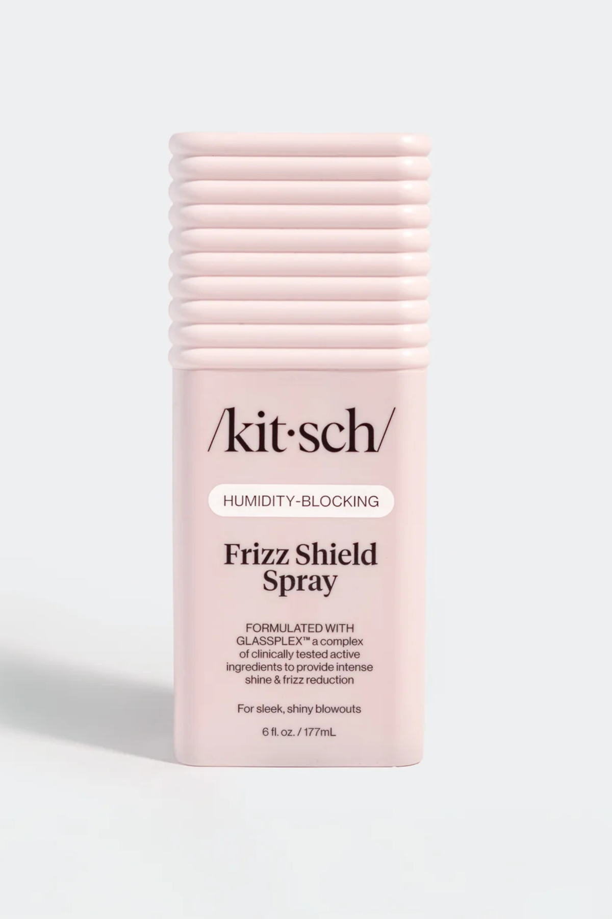 Kit Sch Frizz Shield Spray in a light pink cylindrical bottle with a ribbed cap, shown on a light gray background.