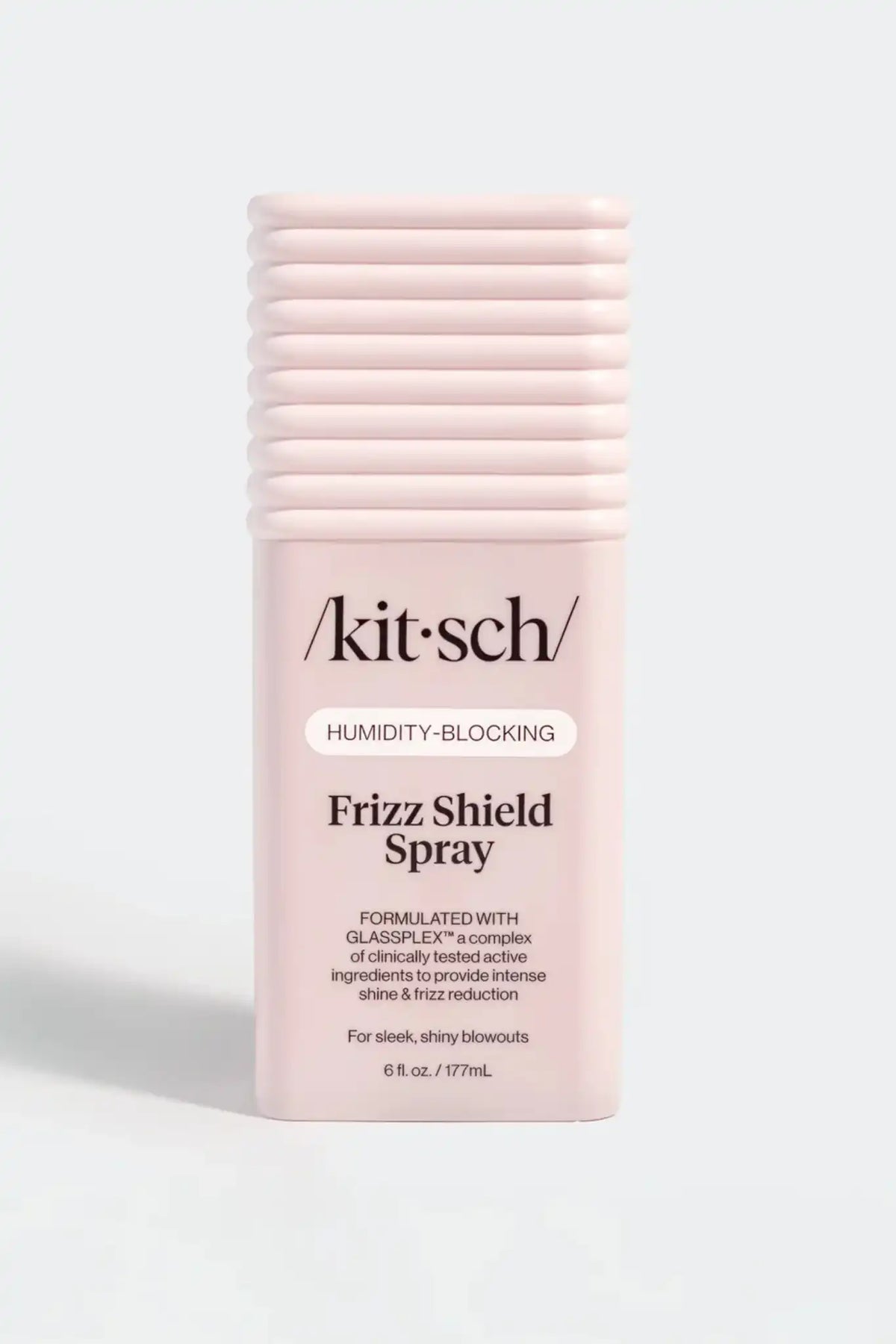 Kit Sch Frizz Shield Spray in a light pink cylindrical bottle with a ribbed cap, shown on a light gray background.