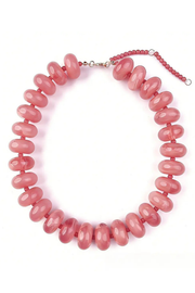 A chunky beaded necklace made of glossy, rounded dusty pink beads, featuring a silver-tone clasp and a matching red beaded extender chain with a silver ring, displayed on a clean white background.