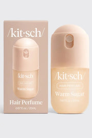 Kit Sch Warm Sugar hair perfume bottle and its matching outer packaging box, both in a soft peach-beige color, set against a light gray background.
