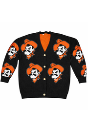 A black knit cardigan sweater featuring a repeating graphic of a cartoon mustached man in an orange cowboy hat and bandana. The cardigan has a bright orange V-neck lining and button closures.