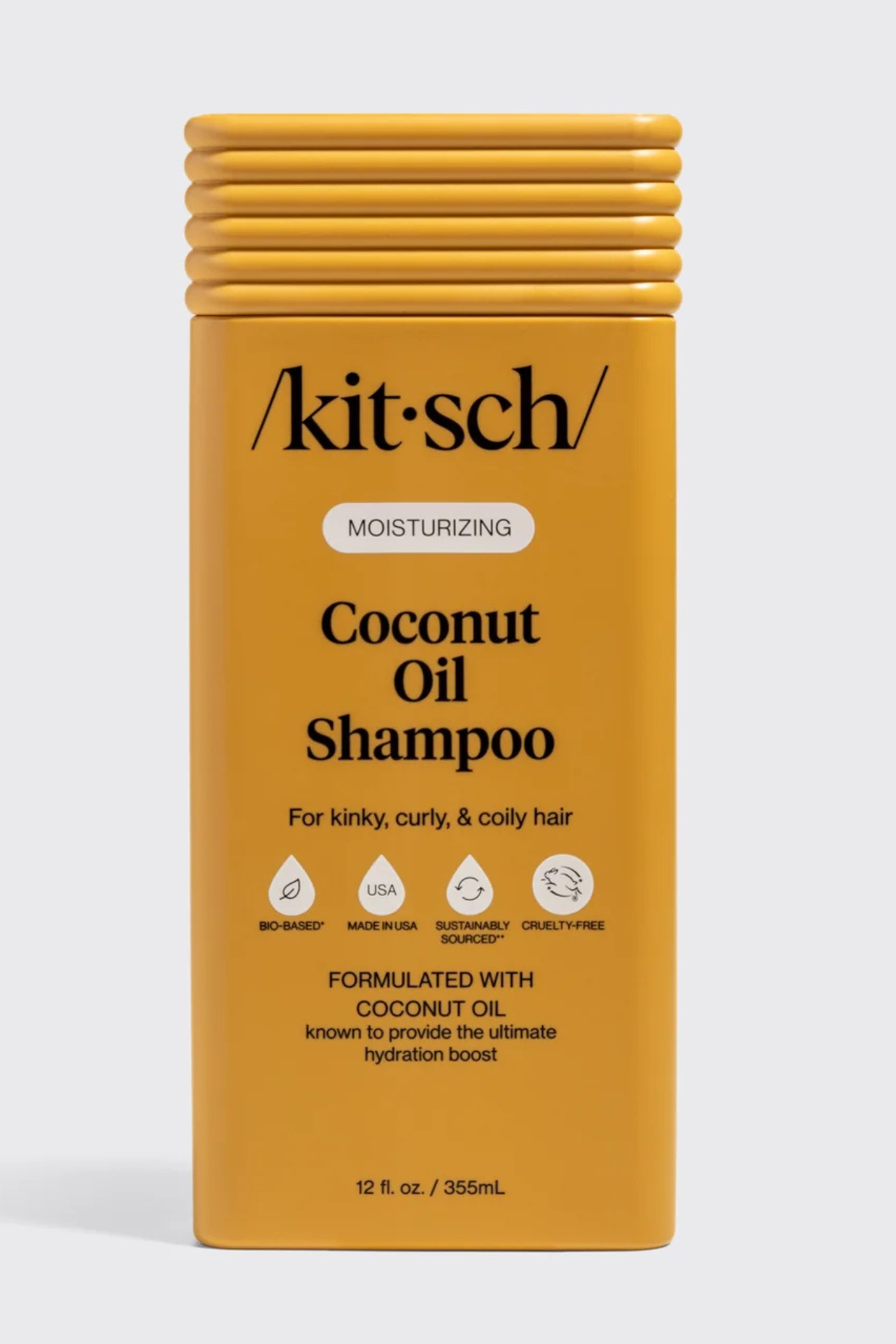 Kitsch Coconut Oil Shampoo in a rectangular yellow bottle with a ribbed cap, shown on a light gray background.
