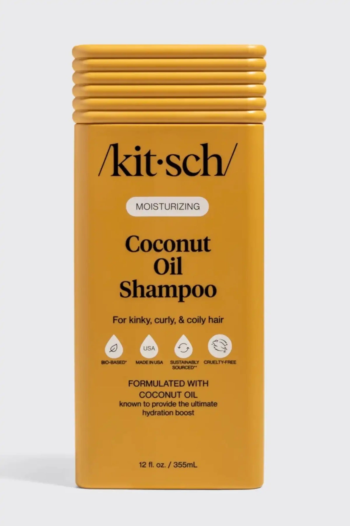Kitsch Coconut Oil Shampoo in a rectangular yellow bottle with a ribbed cap, shown on a light gray background.