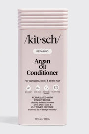 Kitsch Repairing Argan Oil Conditioner in a pale pink rectangular bottle with a ribbed cap, shown on a light gray background.