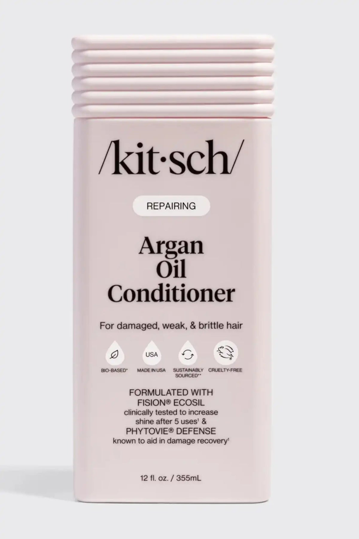 Kitsch Repairing Argan Oil Conditioner in a pale pink rectangular bottle with a ribbed cap, shown on a light gray background.