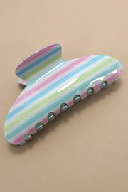 Colorful striped hair clip on a beige background