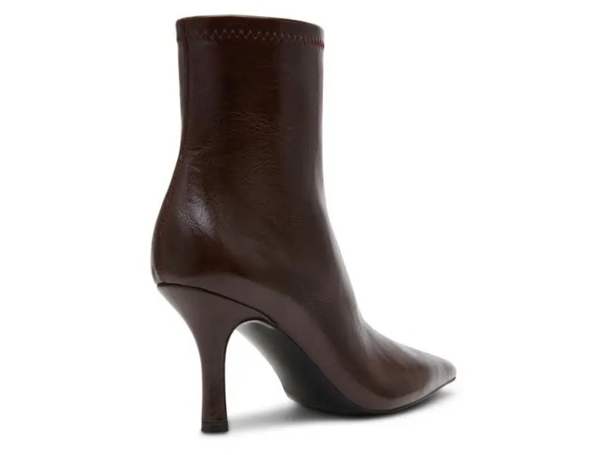 A dark brown leather ankle boot with a pointed toe and a slim kitten heel, shown from a three-quarters rear angle on a white background.