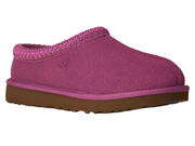 A single UGG slip-on clog shoe in a vibrant magenta pink color, featuring a textured fabric upper, a braided trim around the collar, and a brown rubber sole, shown against a plain white background.