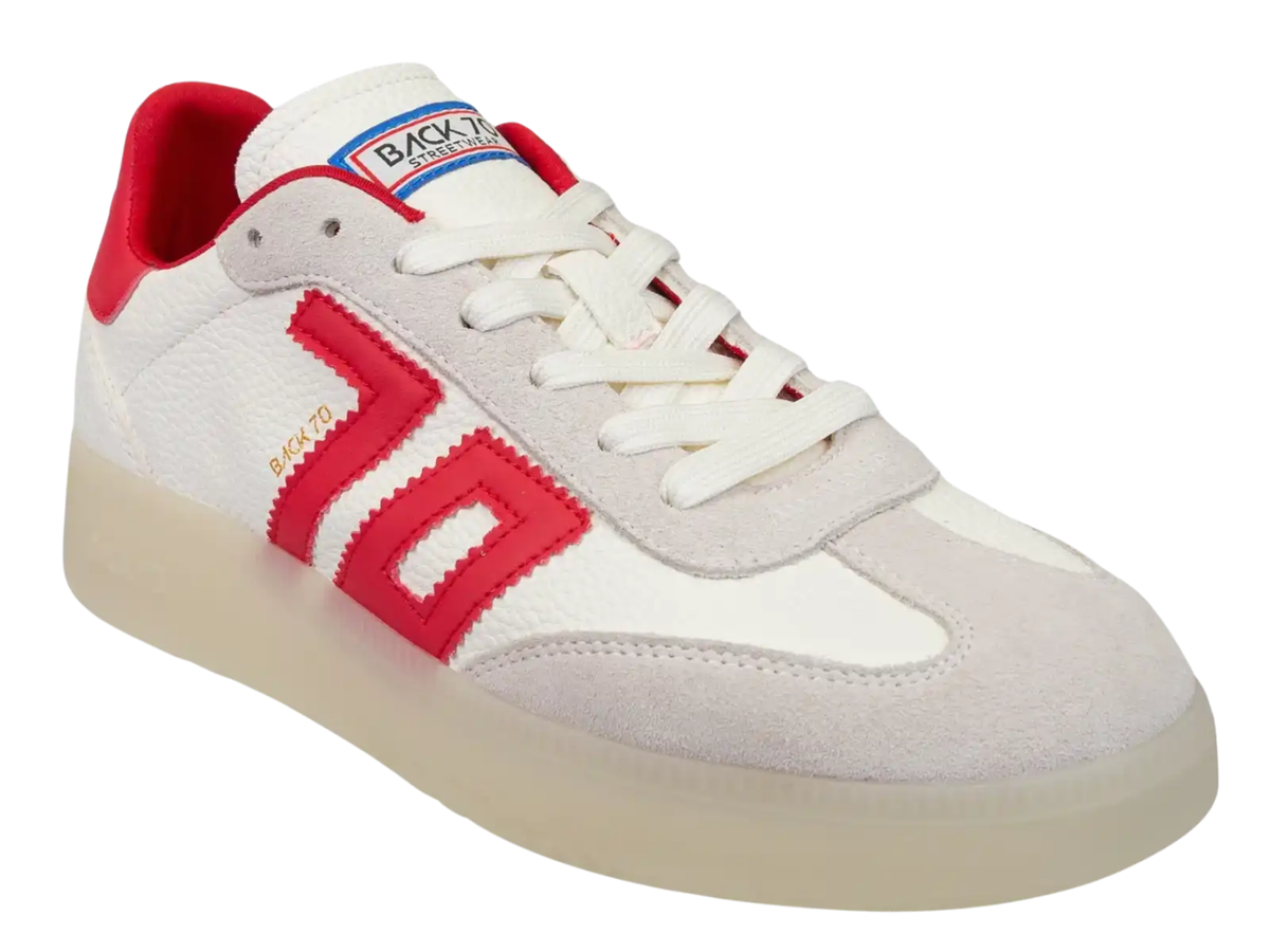 A low-top sneaker by Back To School featuring a white leather and suede upper, a prominent red side logo, a red heel tab, and a translucent cream-colored sole.