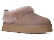 A single slip-on mule slipper in taupe faux suede with a thick tan platform sole and fluffy taupe faux-fur trim, shown from a side profile on a white background.