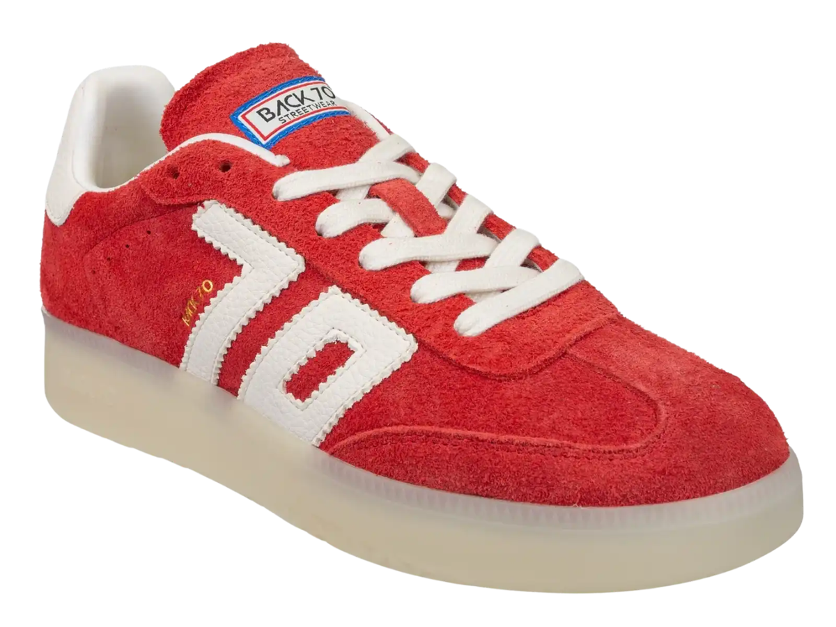 A red suede sneaker with white side stripes, white laces, a white heel tab, and a translucent cream-colored sole. The tongue label shows 'BACK TO SCHOOL' and the side has a small gold 'MCMXIII' detail.