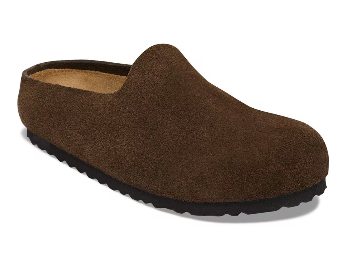 A single dark brown suede slip-on clog shoe with a black textured sole, shown from a three-quarters angle on a white background.