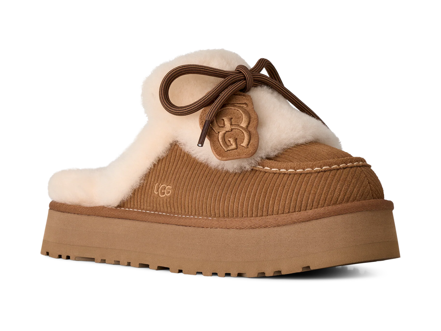 A UGG platform slipper in tan corduroy with a thick cream shearling lining, brown laces, and a tan GG logo patch on the side, shown against a plain white background.