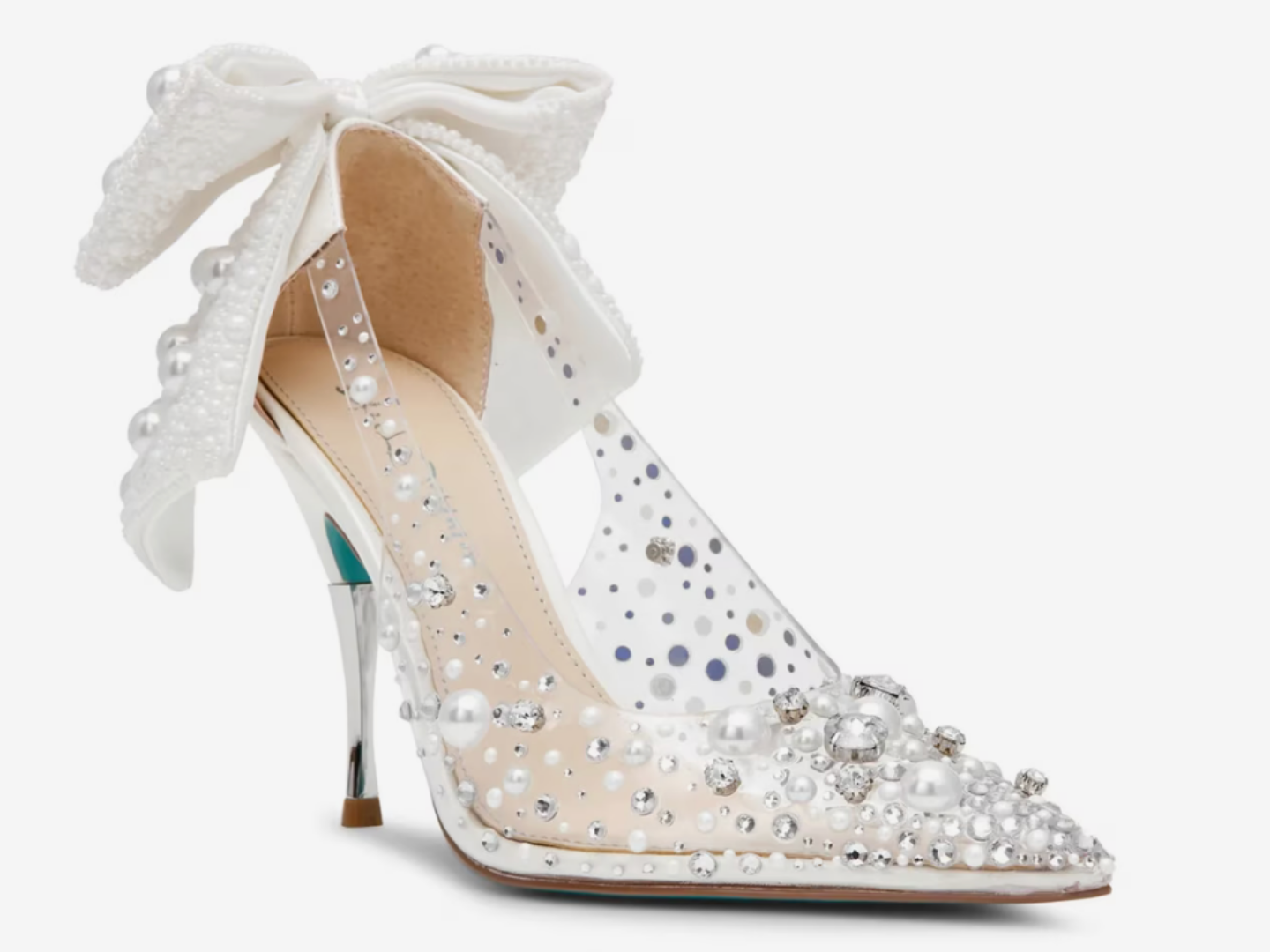 A single white pointed-toe high heel with a large white bow at the ankle, decorated with clear rhinestones and white faux pearls, shown on a light gray background.