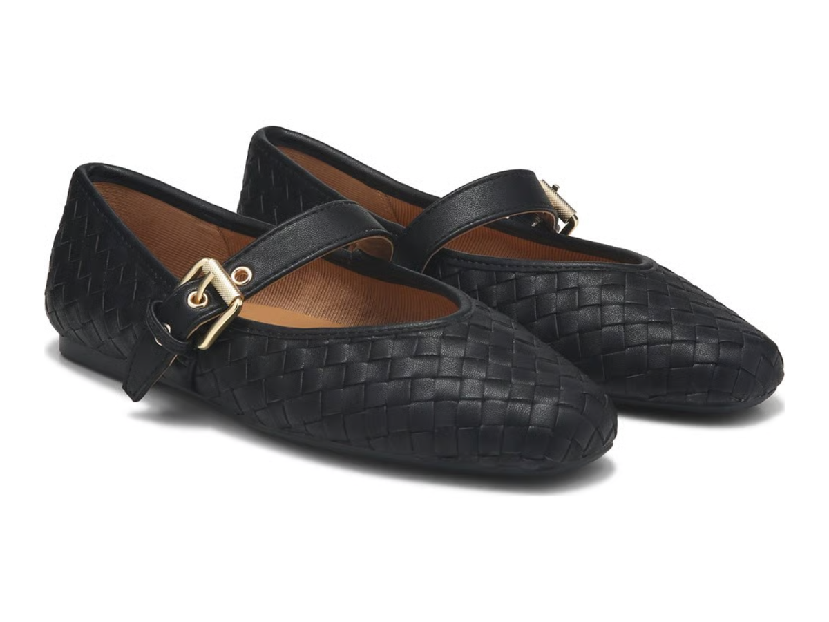A pair of black woven leather Mary Jane flats with gold-tone buckle straps, displayed on a clean white background.