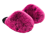 A pair of bright pink faux fur slippers with black soles, shown on a plain white background.