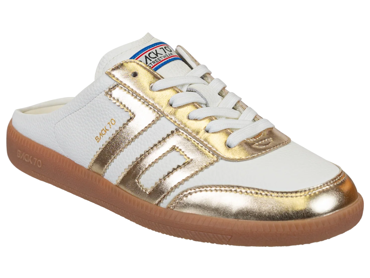 A white and metallic gold slip-on sneaker with white laces, a brown gum sole, and a visible 'BACKTO' brand label on the tongue and side.