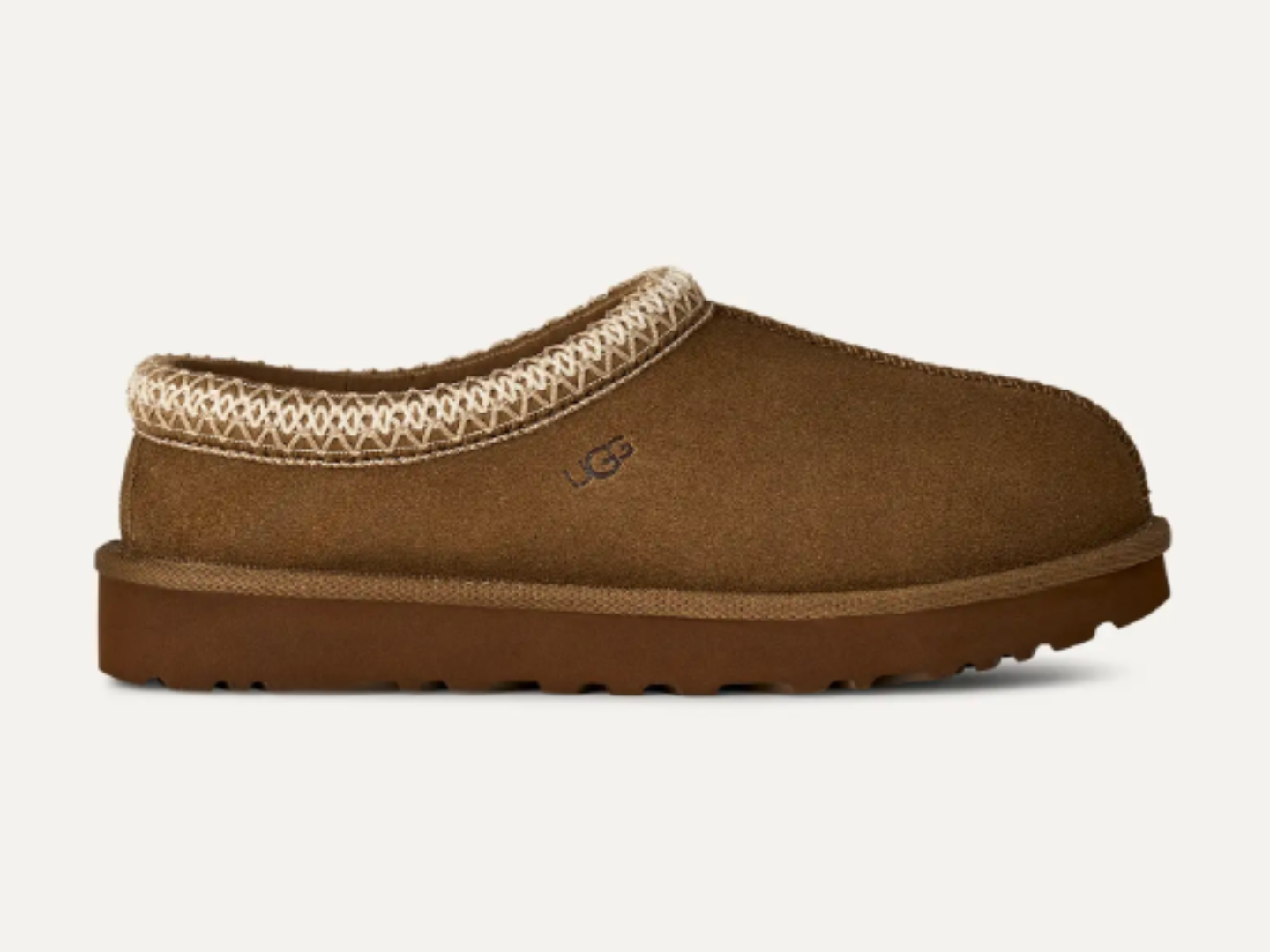 A single brown suede slip-on clog shoe with a beige patterned knit trim and a brown sole, shown against a light off-white background.