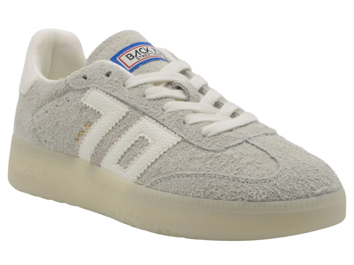A light gray suede Back Market sneaker with white laces, a white side stripe, and a translucent cream sole, shown on a white background.