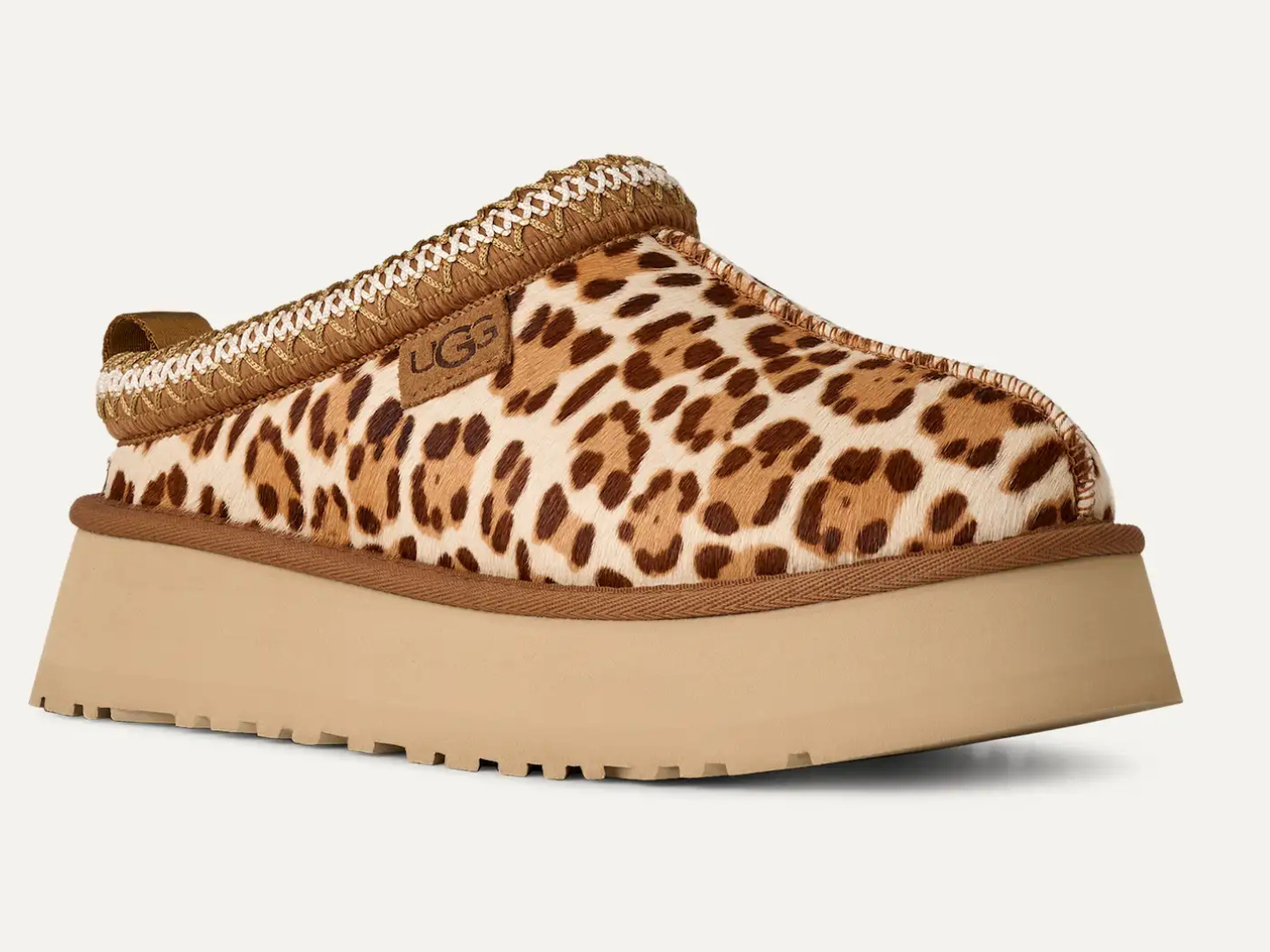 Leopard print UGG slipper on a white background
