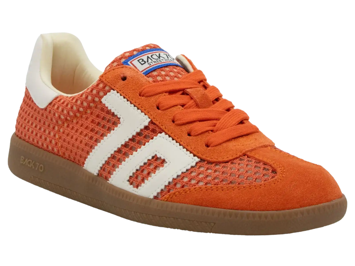 An orange and white BacktoSchool sneaker with a brown gum sole, shown from a three-quarters angle on a white background.